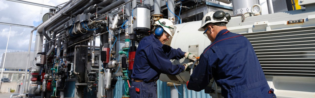 Two people working on machine